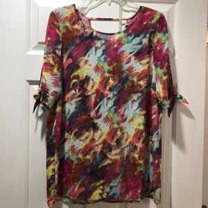 Colorful top with open sleeves.